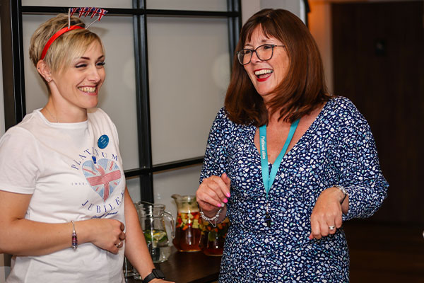 Community Managers laughing together at event