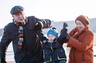 Grandparents playing with their Grandchild by the sea