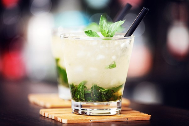 Mint Julep drink on a wooden coaster