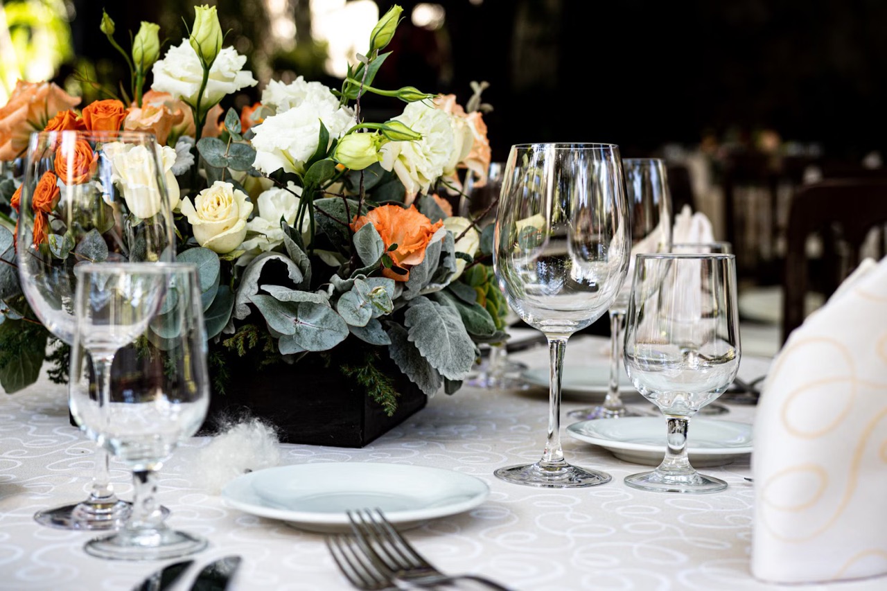 party table laid including wine glasses and flowers