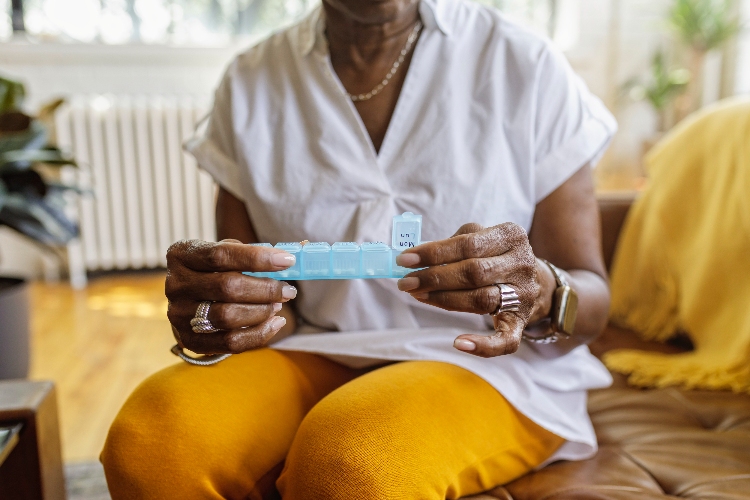 Senior woman with medicine organiser