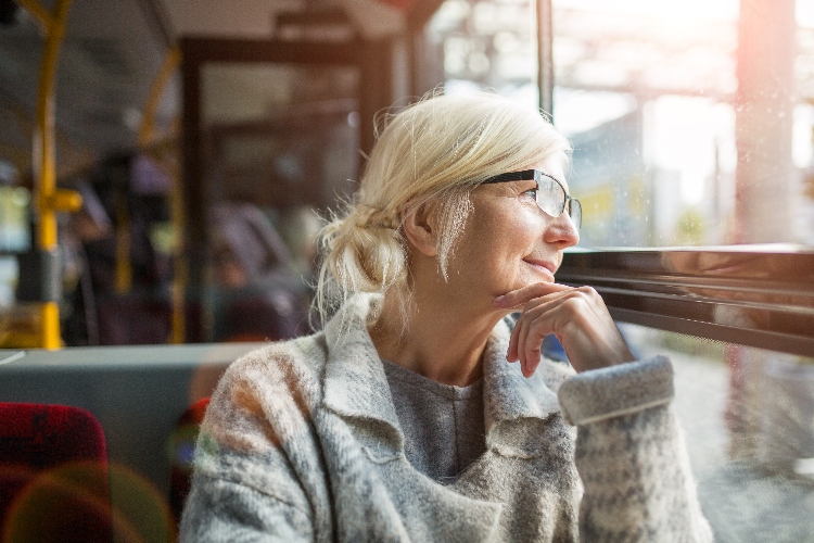 Senior woman on a bus looking out the window