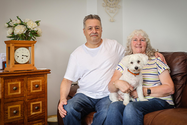 Couple sat in their home with their dog