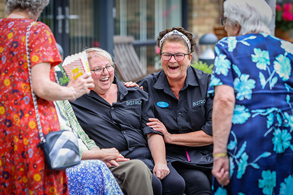 Community Managers laughing outside property 